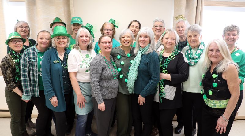 A group of green people pose for a photo.
