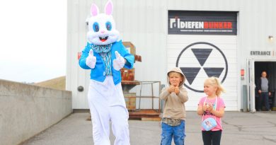 A bunny rabbit stands outside a cold war bunker.