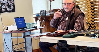 A man speaks at a table.