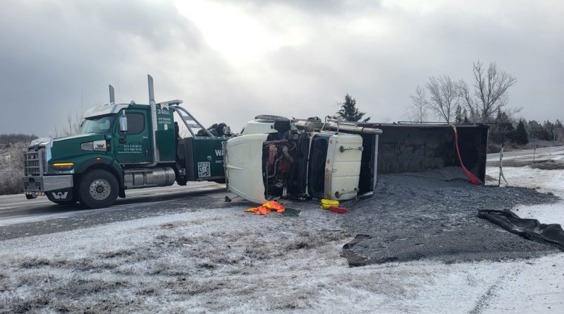 A photo of a flipped over truck.