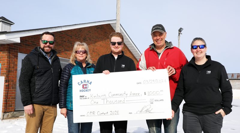 People pose on an ODR with a big cheque.