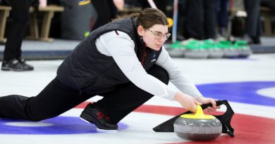 A curler delivers a stone.