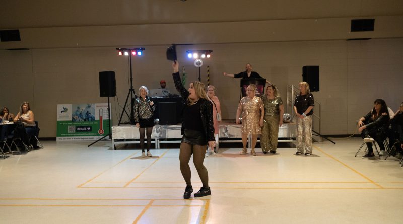 A woman dances on a dance floor.