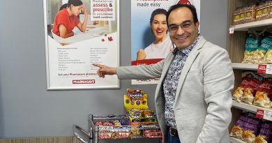 A pharmacist poses in his office.