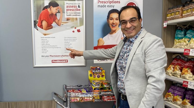 A pharmacist poses in his office.