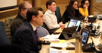 A committee listens during a meeting.