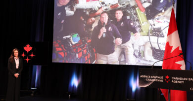 Canadian Hansen sees far side of moon A man on a video screen transmitted from space, answers questions.