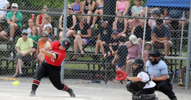 An ump makes a call during a fastball game.