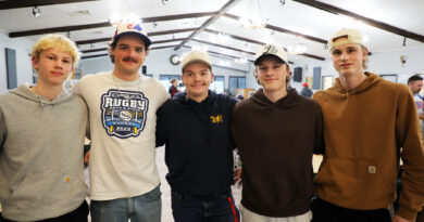 Five people pose for a photo.