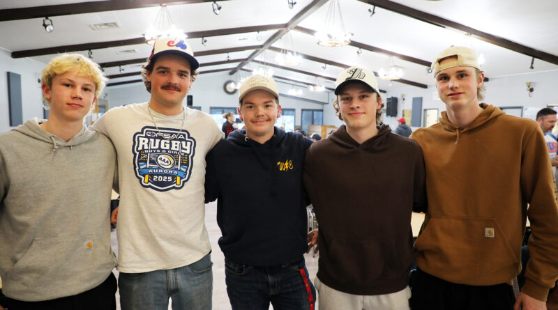 Five people pose for a photo.