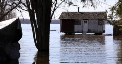 A photo of a house surrounded by water.