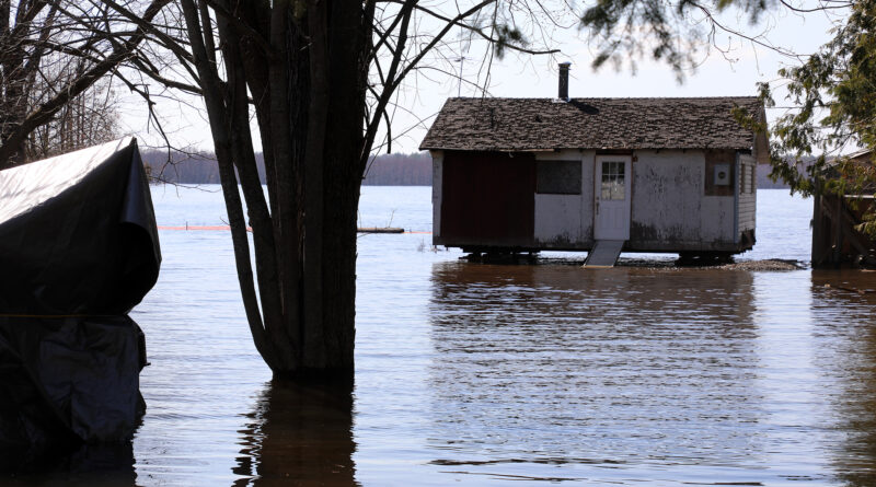 A photo of a house surrounded by water.