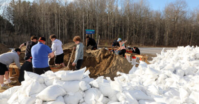 People sandbag at a sandbag station.