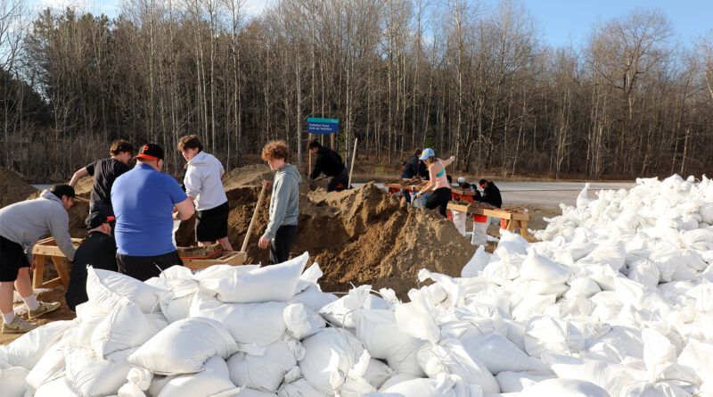 People sandbag at a sandbag station.