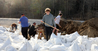 Youth fill sanbags.