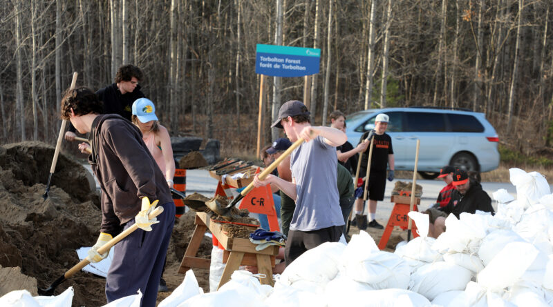 Youth fill sandbags.