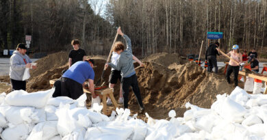 A photo of people filling sandbags.