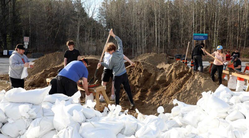 A photo of people filling sandbags.