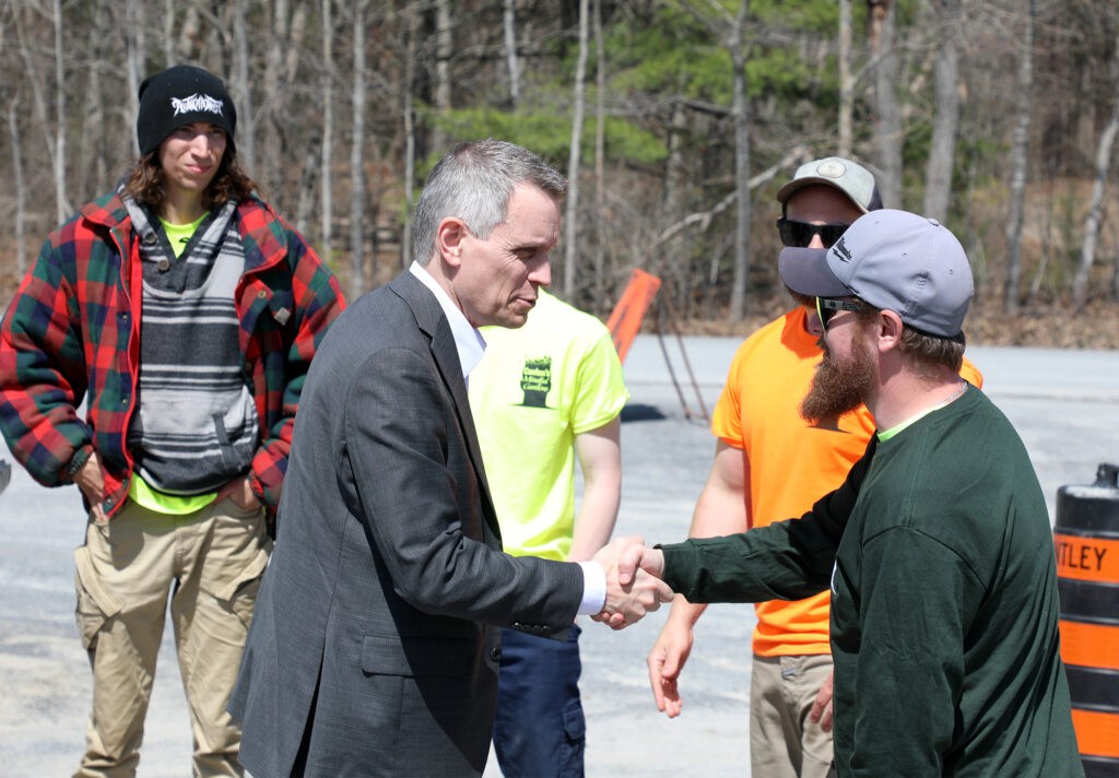 A man shakes another man's hand.
