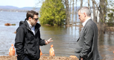 Two people talk on a road.