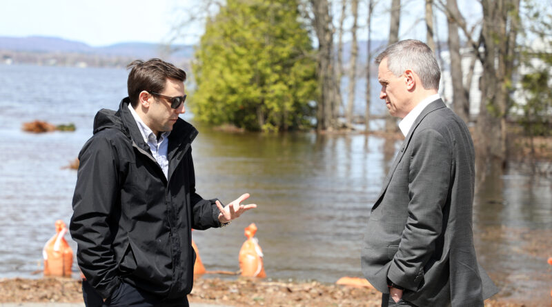 Two people talk on a road.