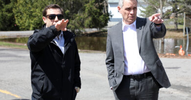 Two people talk on a road.