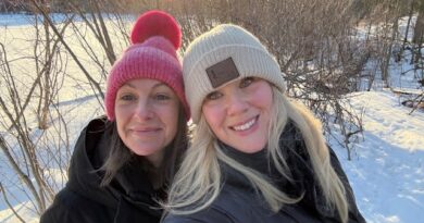 Two people pose for a photo whie on a walk.