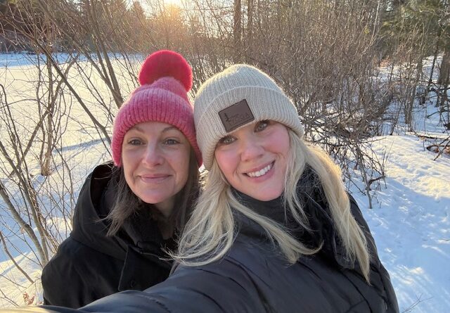 Two people pose for a photo whie on a walk.