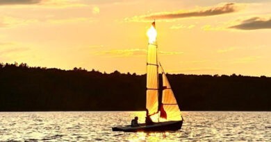 A photo of a boat sailing on the river.