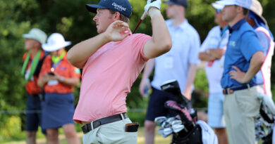 A golfer watches his shot.