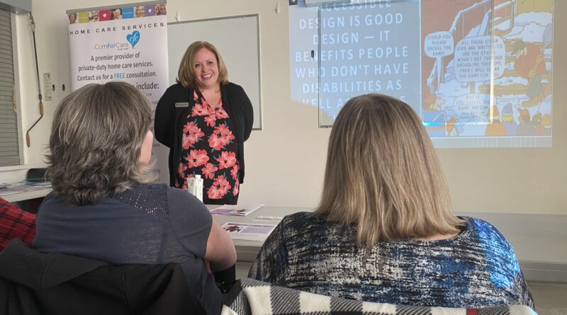 A woman speaks to an audience.