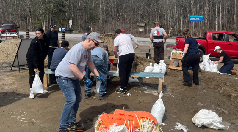 People fill sandbags.