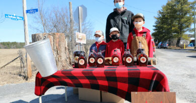 A photo of a maple syrup stand.