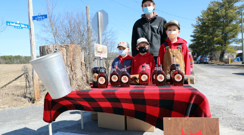 A photo of a maple syrup stand.