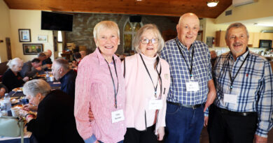 Four people pose for a photo.