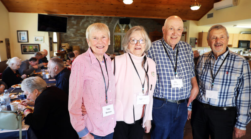 Four people pose for a photo.