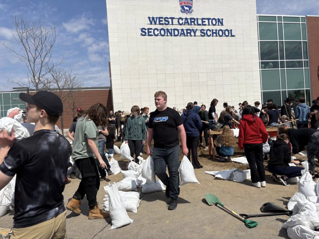 Students fill sandbags.