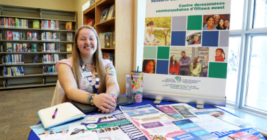 A woman sits at a desk.