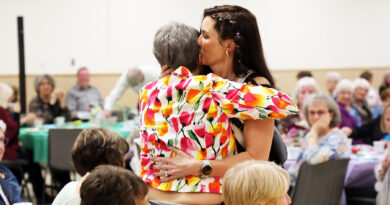 A mother and daughter hug.