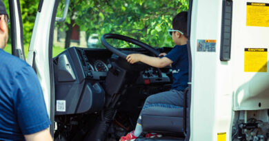A boy sits in a truck.