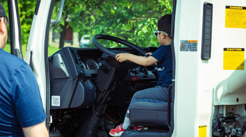 A boy sits in a truck.