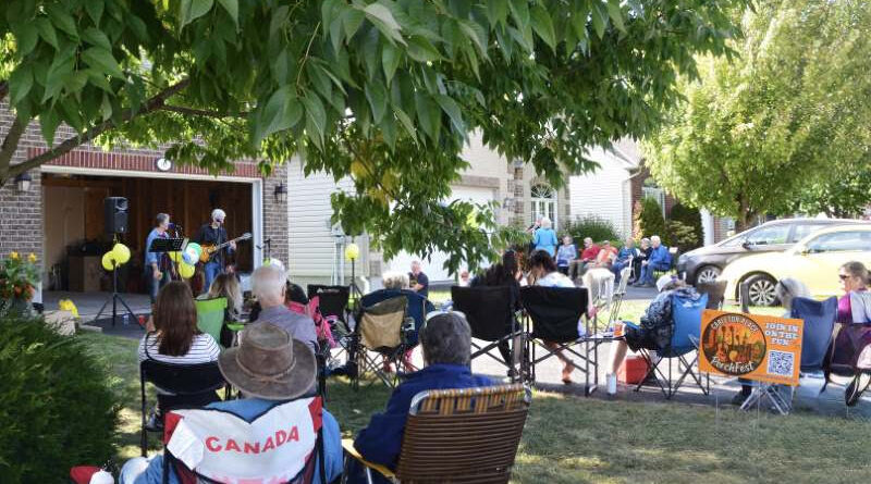 People watch music in a driveway.