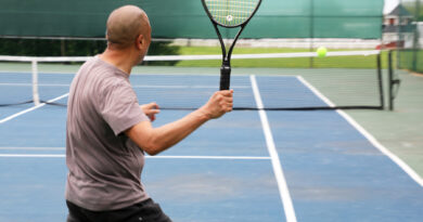 A photo of a man playing tennis.