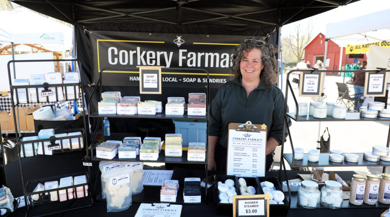 A woman poses in a vendor's booth.