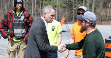 A man shakes hands with another.