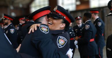 A pair of OPS grads hug,