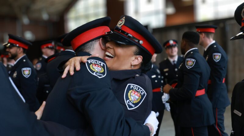A pair of OPS grads hug,