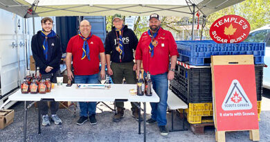 Four people sell syrup.