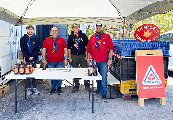 Four people sell syrup.