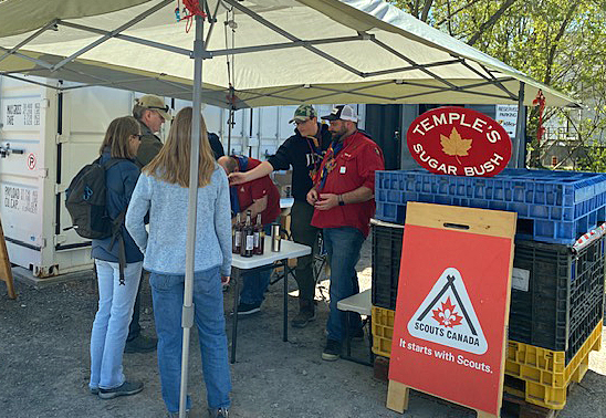 People buy syrup from the Carp 1st Scouts.